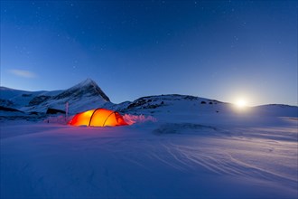 Tent by full moon in the snow