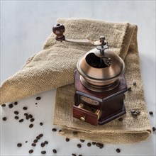 Old coffee grinder on jute bag