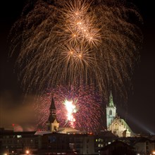 Fireworks over Schwaz on New Year's Eve with Spitalskirche and parish church