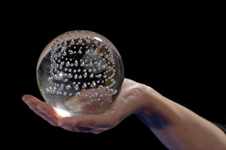 Glass ball in a woman's hand