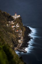 Lighthouse Farol da Ponta do Arnel with sea