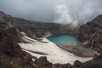 Steaming fumarole with crater lake on the Gorely volcano