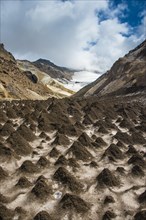 Little sand mounds on a glacier field on Mutnovsky volcano