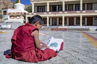A small school boy studding outside at Likir Monastery or Likir Gompa