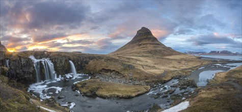 Kirkjufell mountain with Kirkjufellfoss waterfall at sunset