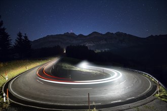 Pass road with cars to Schwagalp with stars and Milky Way