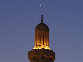 Crescent Moon over Illuminated Minaret