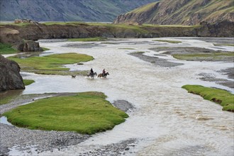 Two Horsemen crossing a river