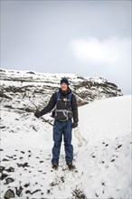 Hiker with ice pick during hike on the glacier