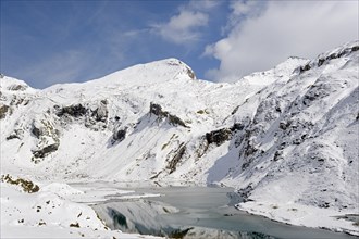 Nassfeld reservoir at 2233 m on the Grossglockner High Alpine Road with snowy mountains