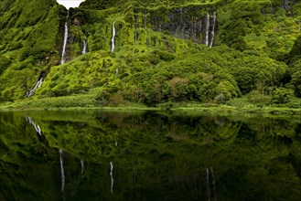 Waterfalls with lake Poco Ribeira do Ferreiro in green landscape