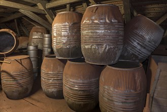 Stacked old barrels covered with bronze dust