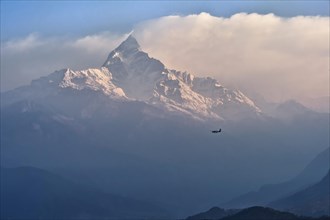 Plane flying to the sacred peak of Machhapuchhare