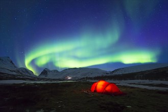 Northern Lights (Aurora borealis) over a tent in winter