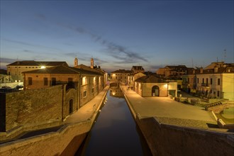 View from the Trepponti bridge on canal with village at dusk