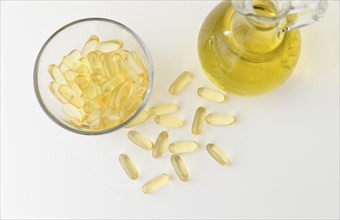 Omega 3 fish oil capsules and bottle on white background