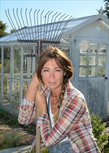 Smiling woman working in her garden