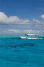 Tourist boat in the turquoise lagoon of Bora Bora