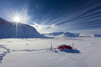 Tent with sun in the snow