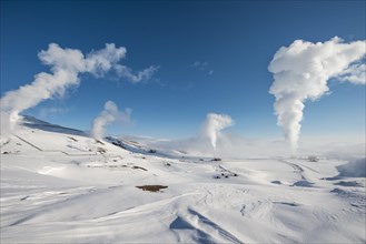 Rising steam in snowy landscape