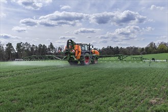 Modern high-tech sprayer in use on a germinating wheat field