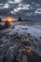 Crumbled coast at sunset