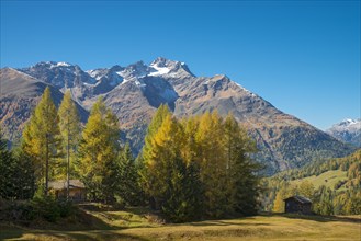 Autumnal mountain landscape with alpine huts