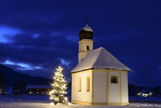 St. Leonhard chapel with illuminated Christmas tree during Christmas time