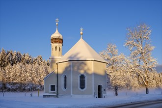 Snow-covered Nikolauskapelle in the morning light