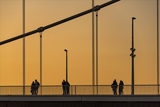 Persons on the Chain Bridge at dusk