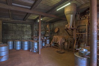 Production room for bronze powder with barrels and machines in a historical metal powder factory