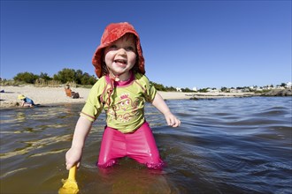 Toddler with sunhat in the water