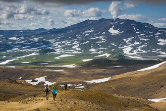 Tourists hiking to the smoking Gorely volcano