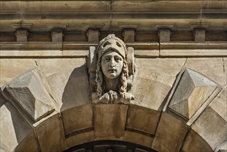 Female head for decoration on sandstone facade