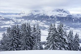 Wilder Kaiser in winter in the clouds