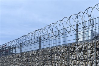 Barbed wire secured stone wall