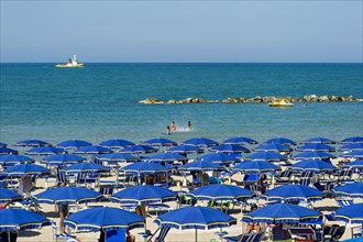 Touristic bathing beach with umbrellas