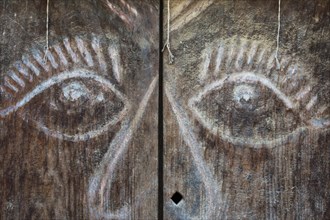 Carved wooden door with a face
