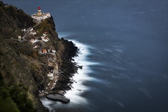 Lighthouse Farol da Ponta do Arnel with sea