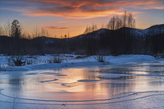 Icy landscape with dramatic sunset
