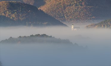 Autumn foggy atmosphere and pilgrimage church at Hafnerberg