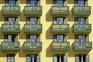 Yellow building facade with balconies