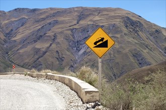Warning sign on gravel road