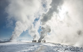 People standing by a fumarole