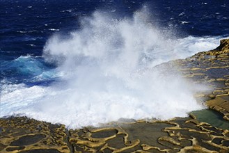 Gozo salt pans by the sea with spray