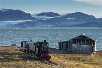 Historic mine train in front of the Kongsfjorden