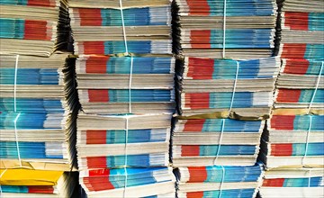 Several stacks with bundles of newspapers
