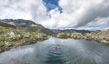 Woman swimming in a small lake