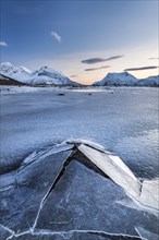 Frozen fjord with broken ice