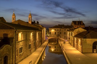 View from the Trepponti bridge on canal with village at dusk